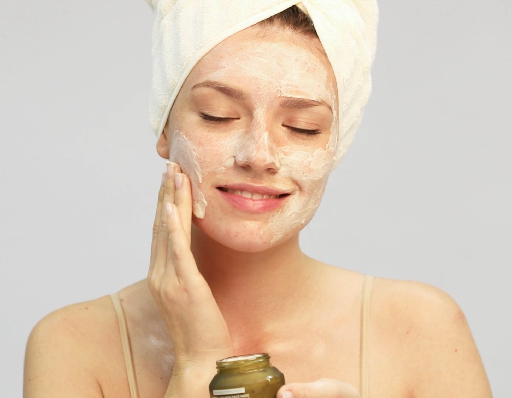 Model applying Purify+Nourish Face Mask